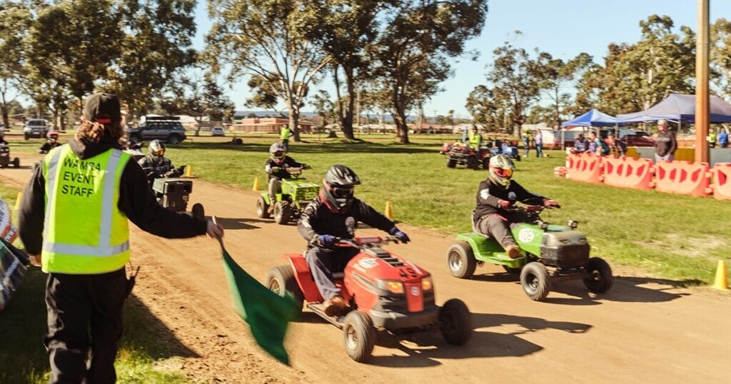 At a lawnmower racing event in Western Australia four racers speed along the track.